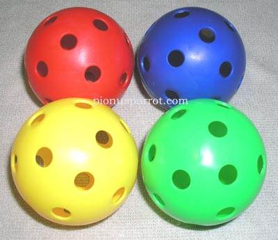 Four solid-colored wiffle balls